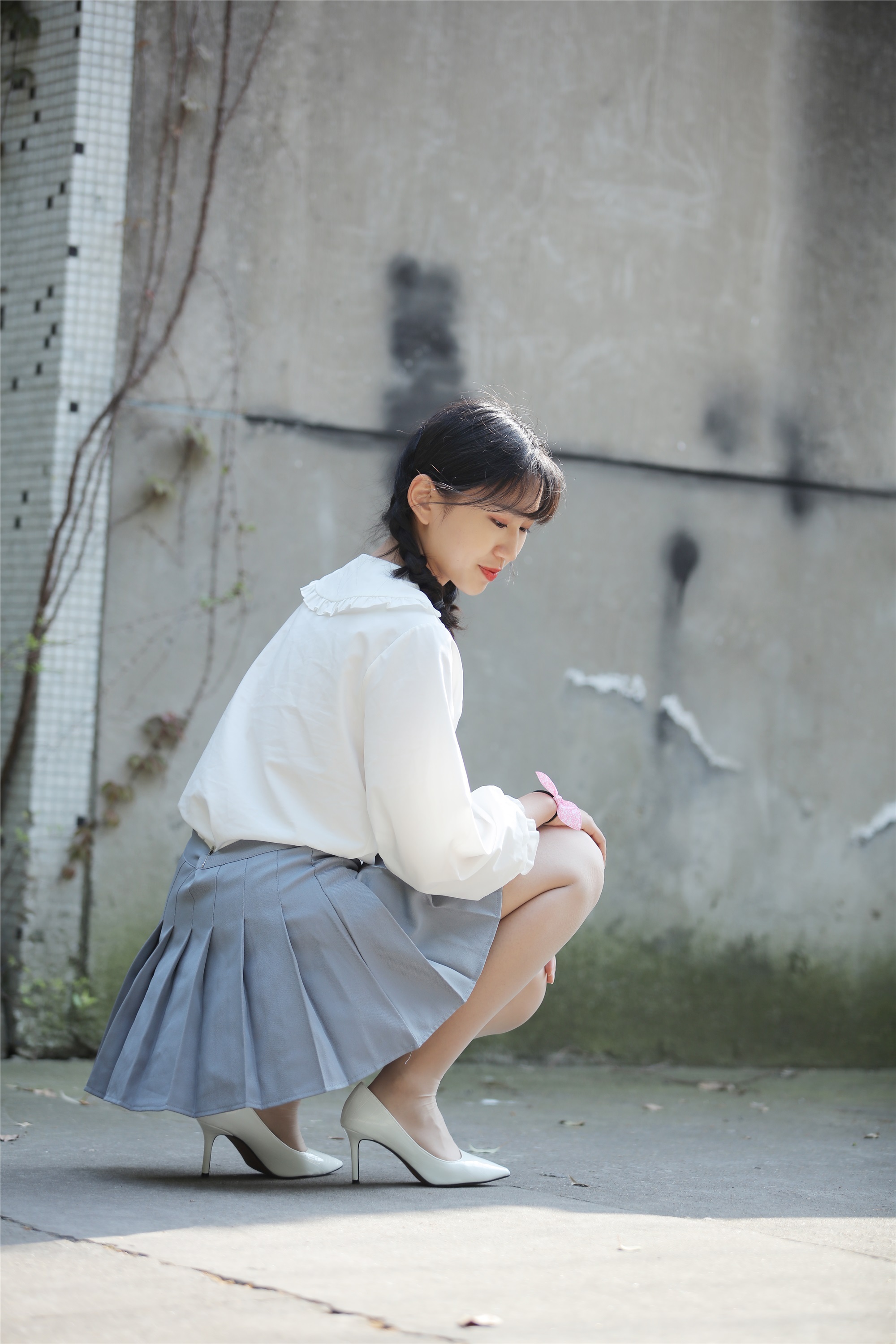 Little Orange with ponytail and white pleated skirt